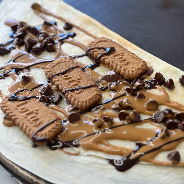 A Manasiri Crepe with Lotus Biscoff cookies, chocolate chips, and chocolate and caramel drizzle.